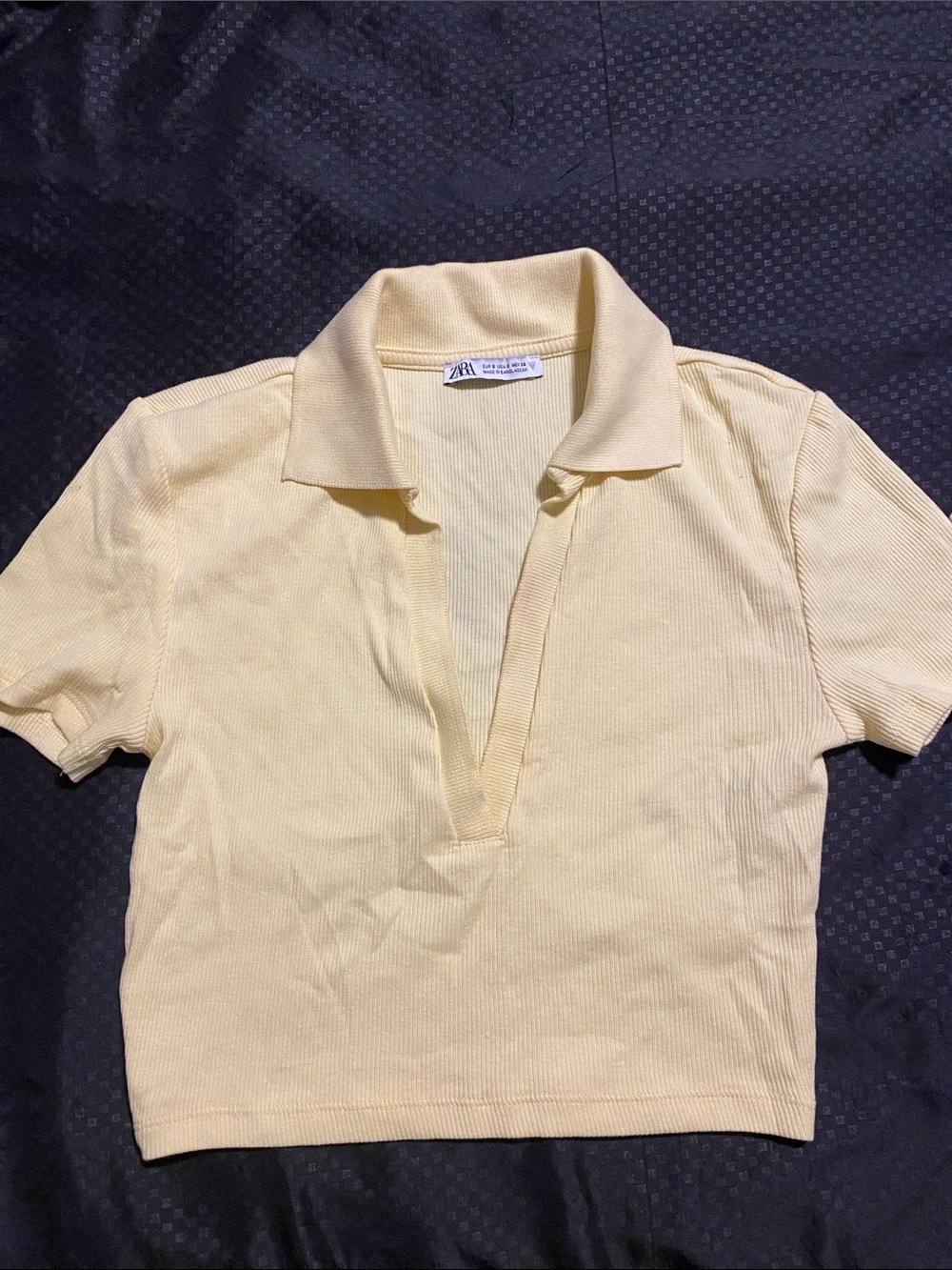 Zara woman Pale Yellow Ribbed Short Sleeve Polo crop top has a light stain